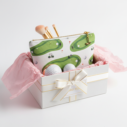 Golf-themed makeup bag presented as gift in pink box with tissue paper